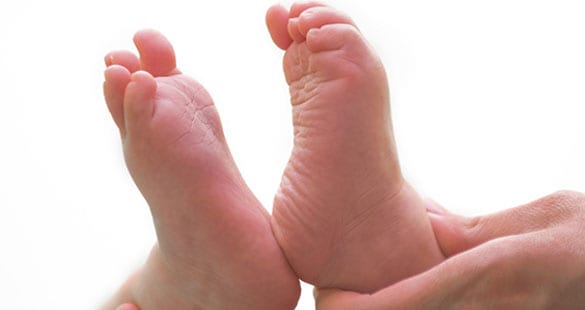 Examining baby's feet.