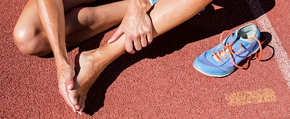 Female athlete suffering with neuroma on the bottom of her feet.