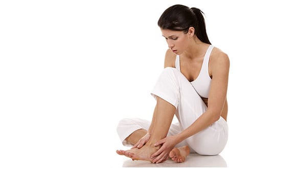 Woman with foot pain because of peripheral neuropathy.