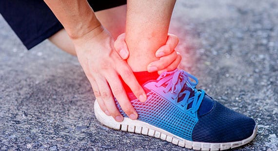 Female athlete suffering from ankle sprain.