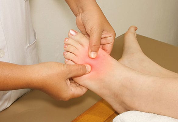 Specialist evaluating foot before TOPAZ treatment.
